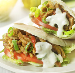 pita stuffed with shawarma tomato and lettuce