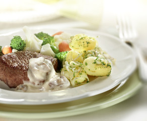 Steak served with potatoes and cauliflower