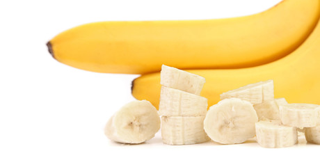 Fototapeta premium Ripe bananas and piece isolated on white