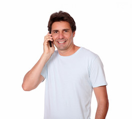Fototapeta premium Charismatic male smiling speaking on cellphone