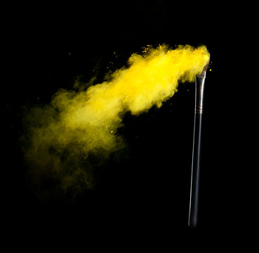 Colored powder with brush, isolated on black background