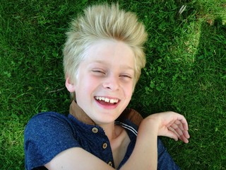 boy lying on grass