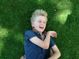 boy lying on grass