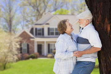 Happy Senior Couple in Front Yard of House