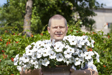 Gardener with flowers in the garden