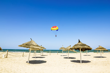 Parachute flies over the Mediterranean Sea and the beaches of Tu
