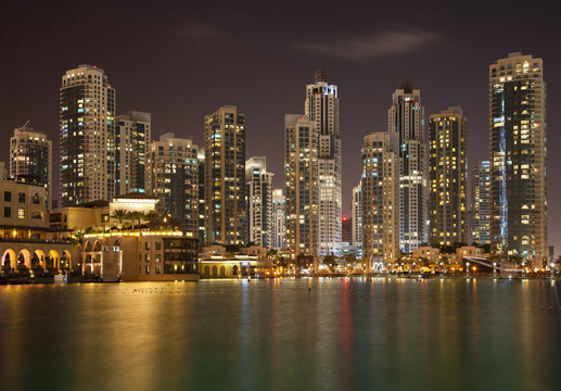 Dubai Skyline and Reflection of Illuminated Skyscrapers on Water