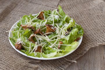salad with mushrooms (chanterelles), parmesan, lettuce