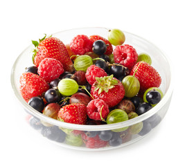 Bowl of fresh ripe berries on white background