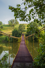 metal suspension bridge over the river