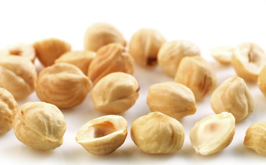 Closeup view of hazelnuts over white background