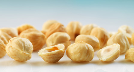 Closeup view of hazelnuts over white background