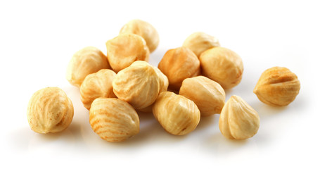 Closeup view of hazelnuts over white background