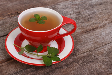 Herbal tea with mint on an old wooden table