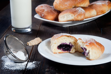 Obraz na płótnie Canvas Sweet bun with blueberries jam