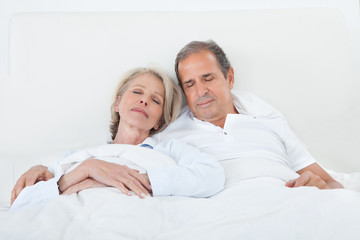 Happy Senior Couple On Sleeping Bed