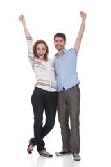 Obraz premium Happy Young Couple Raising Hands