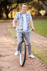 teenage boy riding a bicycle