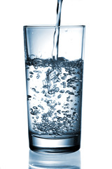 water pouring in glass isolated on white background