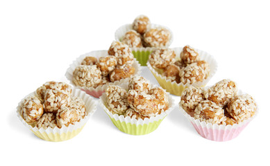 Tasty peanuts with sesame and caramel, isolated on white