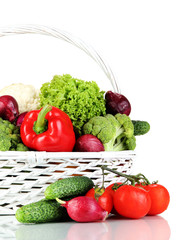 Fresh vegetables in white wicker basket on grey background