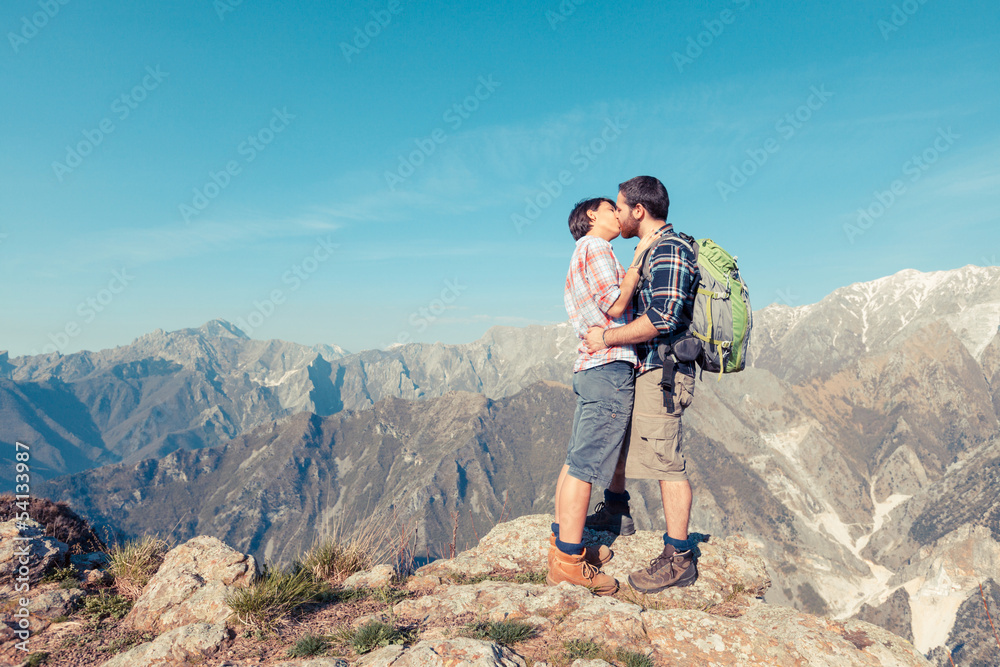 Wall mural Couple Kissing at Top of Mountain