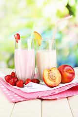 Delicious milk shakes with strawberries and peach