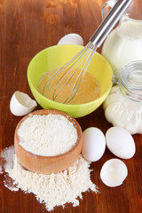 Ingredients for dough on wooden table close-up