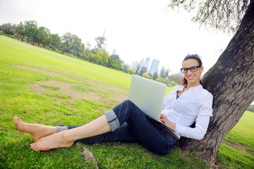Obraz premium woman with laptop in park