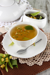 Cup of tea with linden on napkins on    wooden table