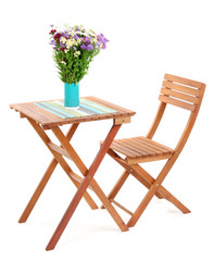 Wooden table with flower isolated on white