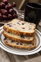 Blueberry bread with red cherries and tea