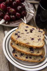 Blueberry bread with red cherries and tea