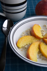 Peaches oatmeal on a blue tablecloth served