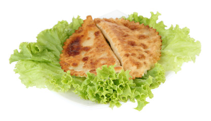 Tasty chebureks with fresh herbs on plate, close-up