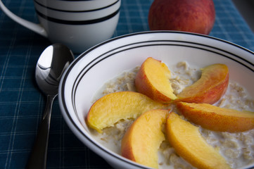 Peaches oatmeal on a blue tablecloth served