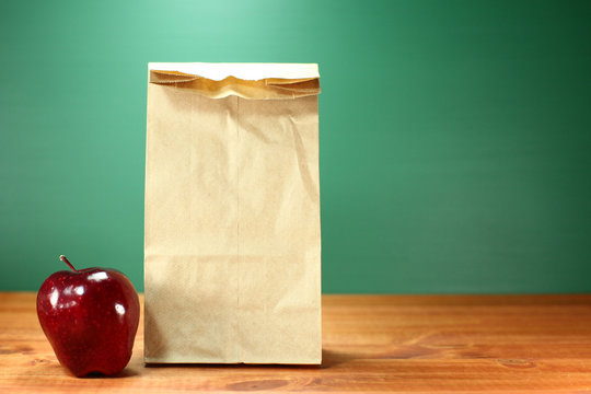 School Lunch Sack Sitting On Teacher Desk