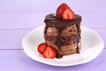 Chocolate cake with strawberry on wooden table close-up