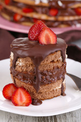 Chocolate cake with strawberry on wooden table close-up