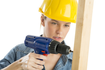 Construction Worker Using Cordless Drill On Wooden Plank