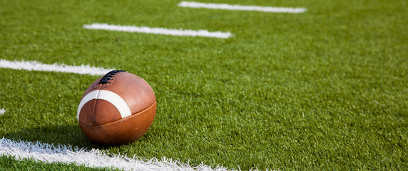 An American football on field - Powered by Adobe