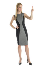 Fototapeta premium Businesswoman With Hand On Hip Pointing Upwards