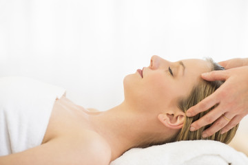 Fototapeta na wymiar Woman Receiving Head Massage At Health Spa