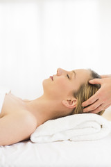 Obraz na płótnie Canvas Relaxed Woman Receiving Head Massage At Health Spa