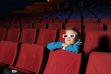 Little boy watching a movie in 3D glasses