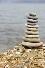 Balanced stack of stones over sea background