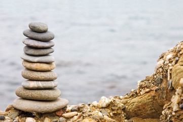 Balanced stack of stones over sea background