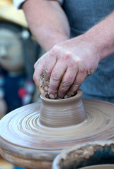 Hands working on pottery wheel