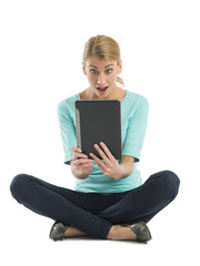 Amazed Young Woman Looking At Digital Tablet