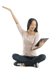 Cheerful Woman With Hand Raised Looking At Digital Tablet